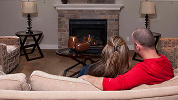 man and woman relaxing on sofa